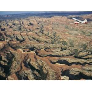  A Small Aircraft Hovers Above Above Canyonlands National Park 
