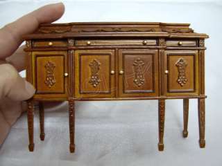 High end doll house carved buffet finished in walnut  