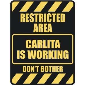   RESTRICTED AREA CARLITA IS WORKING  PARKING SIGN