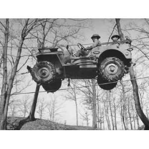  Group of Us Soldiers Pulling a Jeep over a Ravine Using 