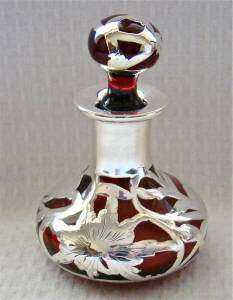   for action is a perfume bottle that is ruby or cranberry red in color